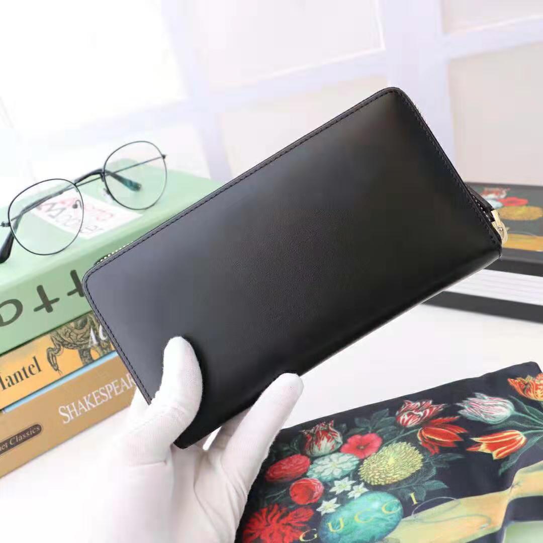 G*u*i gg unisex leather zip around wallet with G*u*i logo in black leather