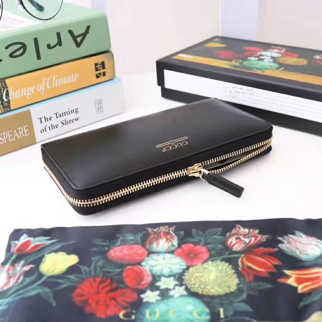 G*u*i gg unisex leather zip around wallet with G*u*i logo in black leather