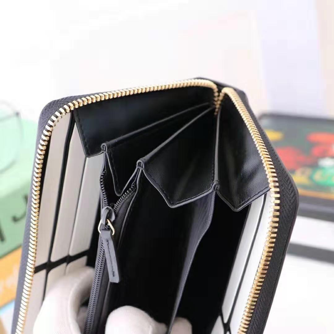 G*u*i gg unisex leather zip around wallet with G*u*i logo in black leather