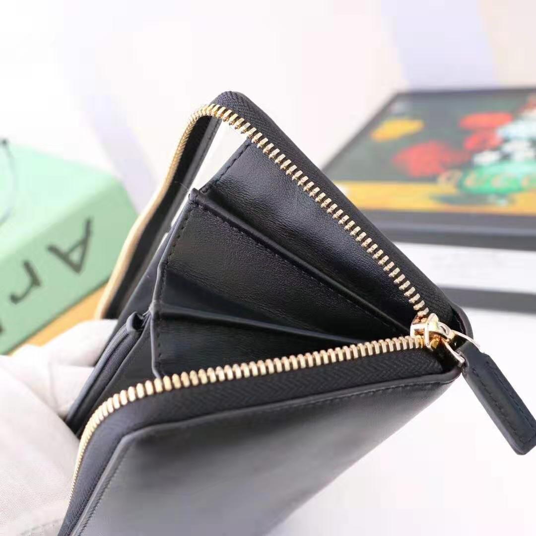 G*u*i gg unisex leather zip around wallet with G*u*i logo in black leather
